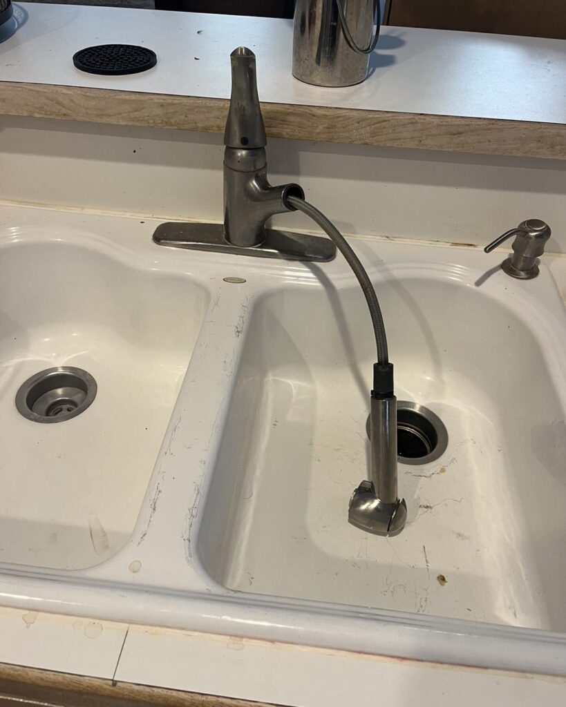 Rhead Plumbing installed new fixtures for this kitchen sink! Looks great! This is the before image.